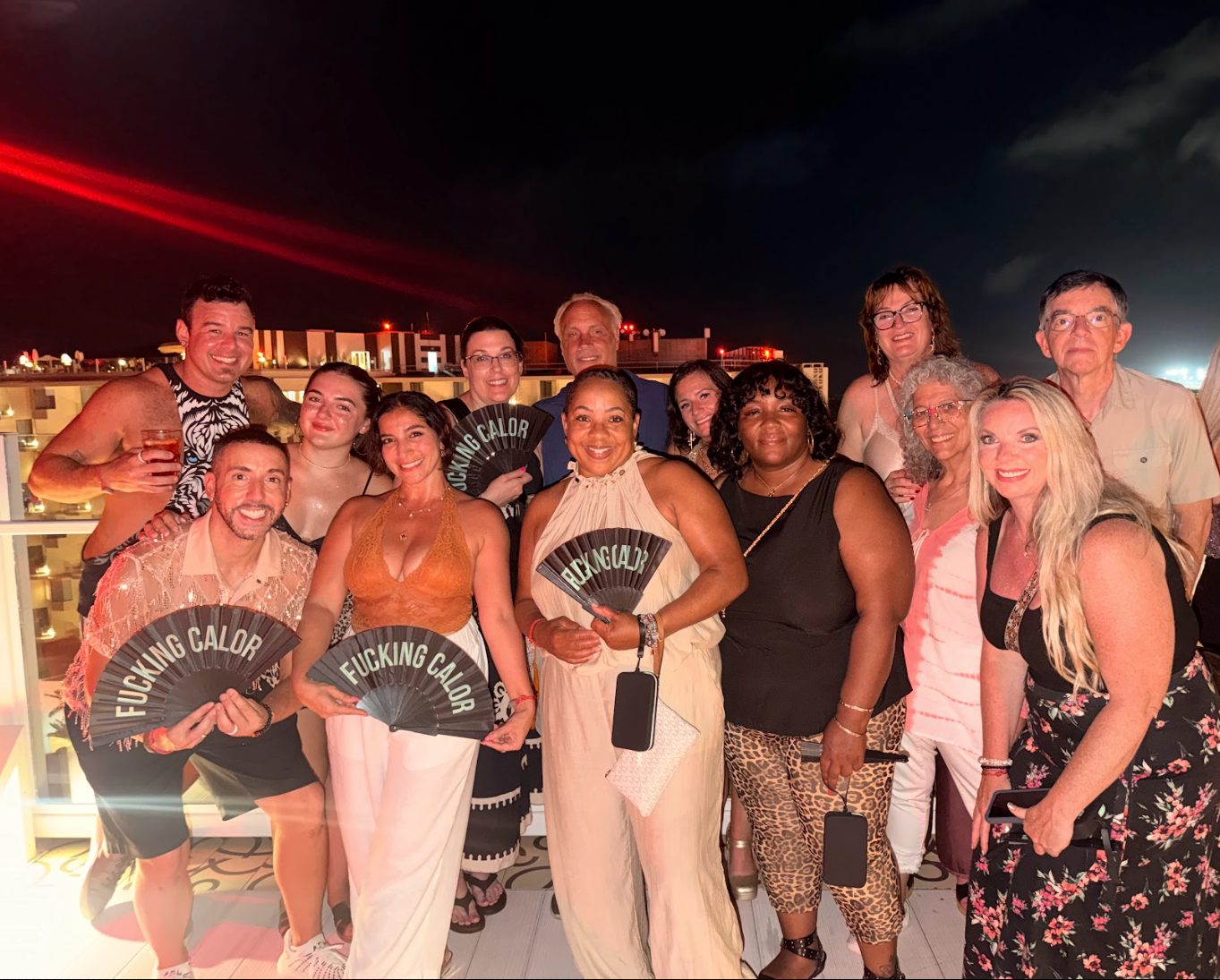 Group of friends with fans at a rooftop party