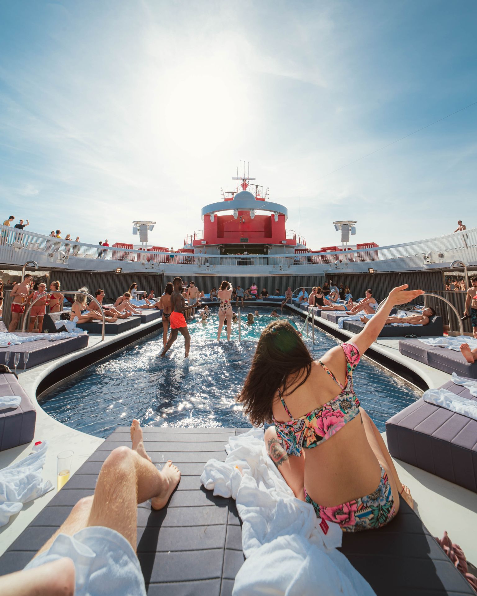 Guests relaxing poolside on deck